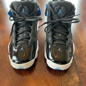 Jordan 11 Kids Black and University Blue Retro Sneakers